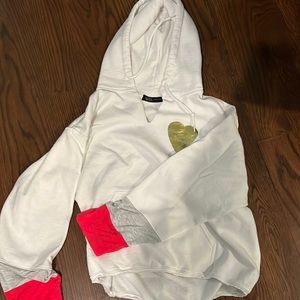 Boutique hoodie, white with golden shear and multi color sleeve detail.